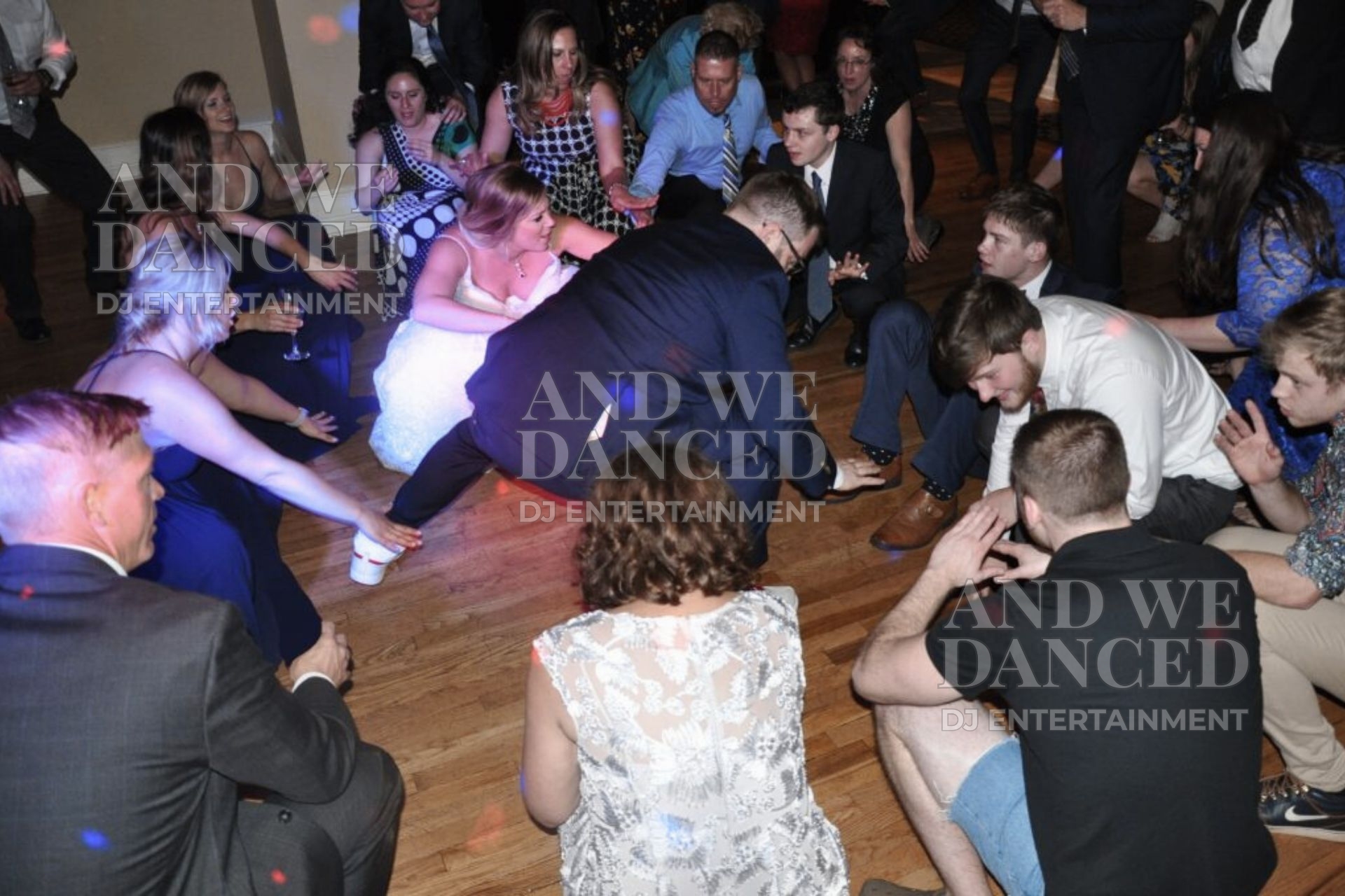 Happy couple and guests get low on the dance floor.