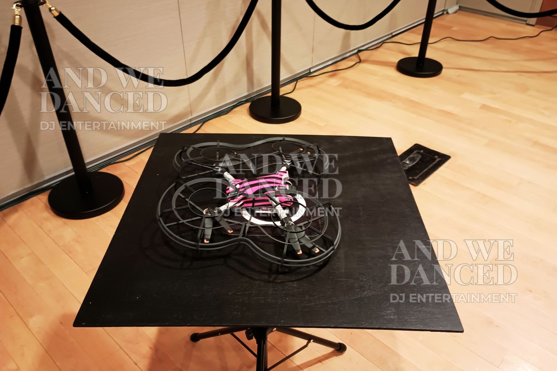 Small protective-guard drone on a platform used for 360DroneBot and GlamDroneBot video booths.